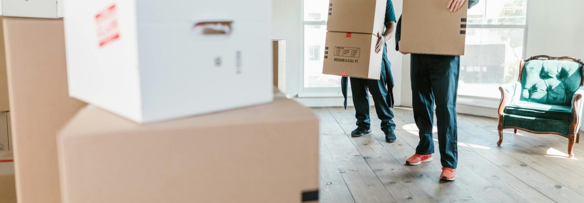 Professional house movers carrying furniture during a relocation in Kenya.