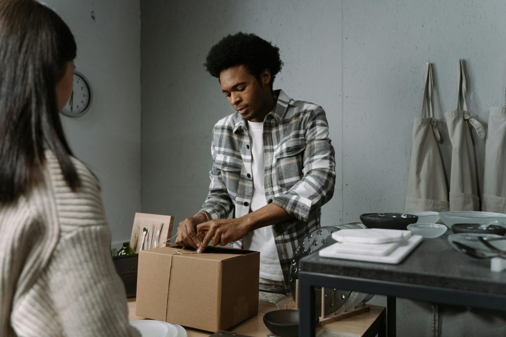 Professional movers packing boxes inside a residential home, providing trusted moving services in Kenya.