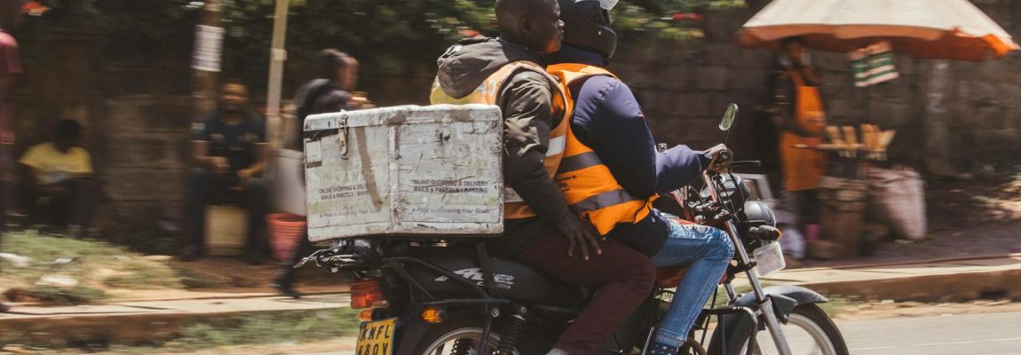 Movers carrying furniture into a moving truck outside a home in Nairobi.