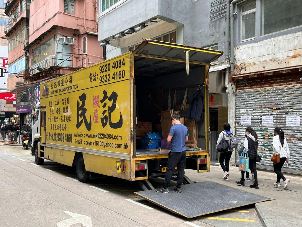 A professional moving truck with movers loading furniture in Redhill, Nairobi.