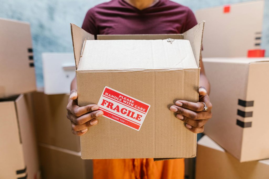 Professional movers carrying furniture into a moving truck at a residential house in Milimani, Kitengela.