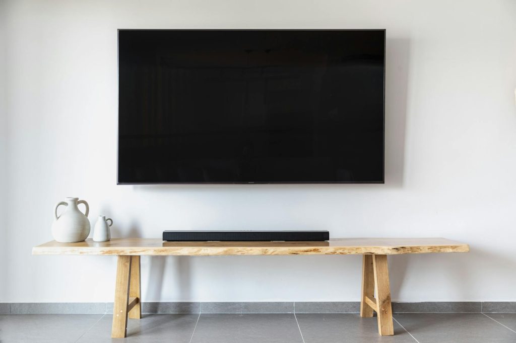Professional installation of a TV bracket on a wall.