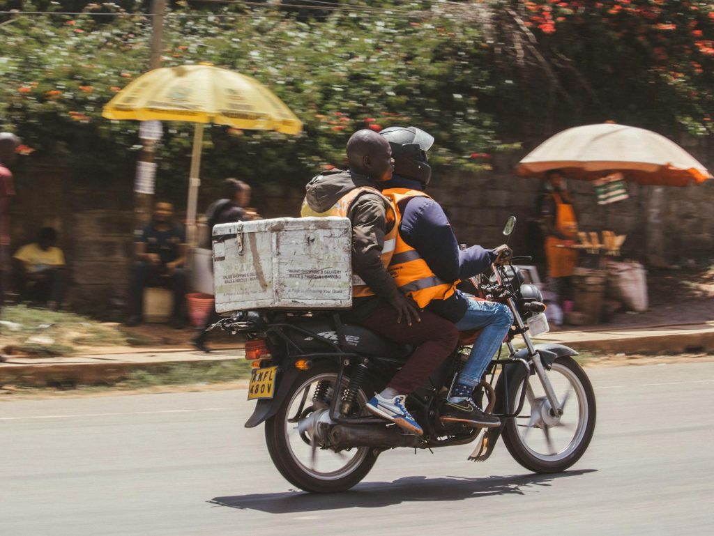 Two movers carrying furniture through a wooden doorway during a move.