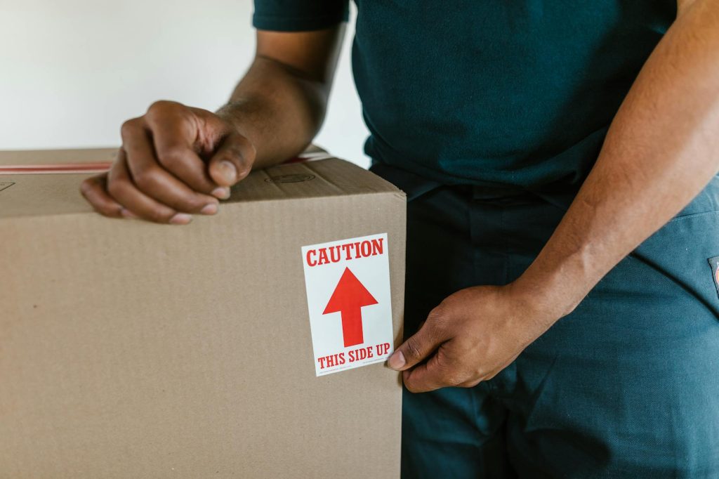 Two movers carry furniture into a moving truck in Nairobi.
