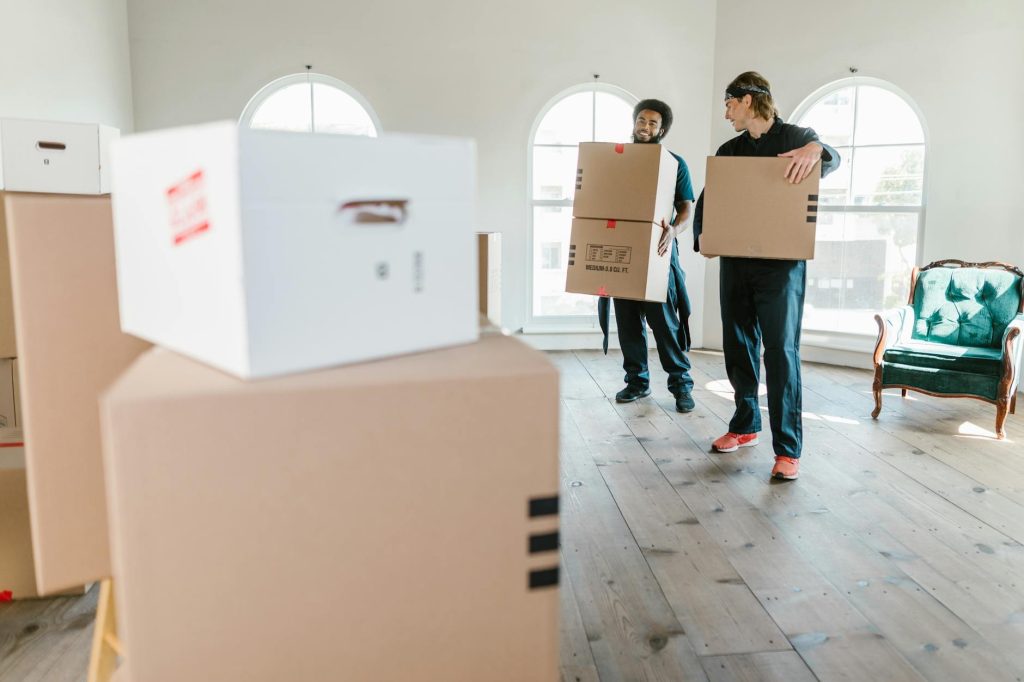 Household items packed in boxes inside a room, labeled ready for moving.