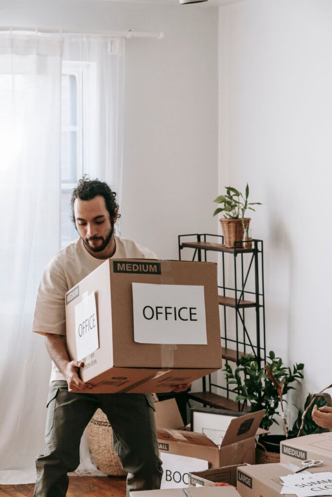 Professional movers carrying furniture into a modern house office in Nairobi.