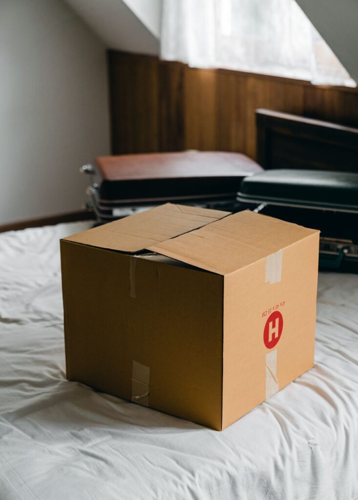 A professional moving team loads furniture from a three-bedroom house into a truck in Kenya.