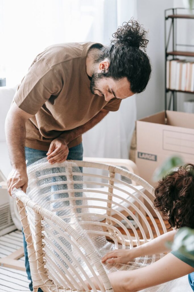 Professional house movers in Syokimau, Kenya, carrying furniture.