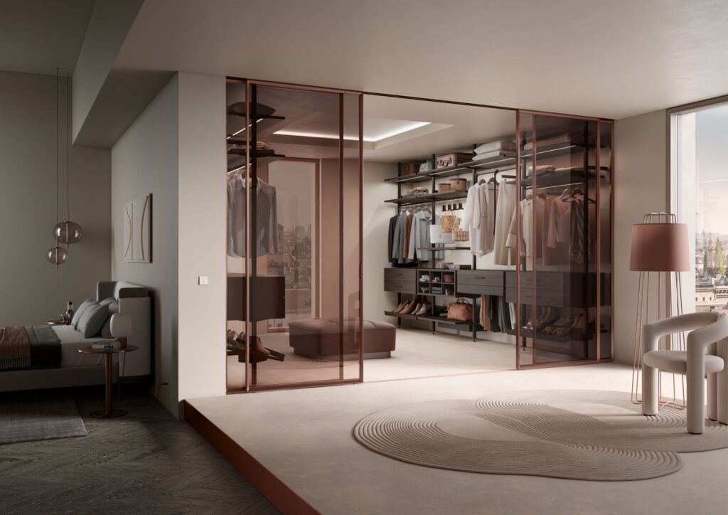 A team of movers carefully transports a luxury wardrobe through a modern lobby, ensuring the high-end designer wear is protec