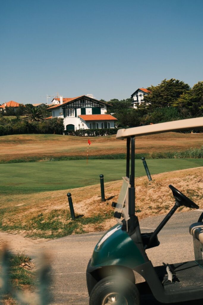 Reliable movers loading boxes near a golf course estate.