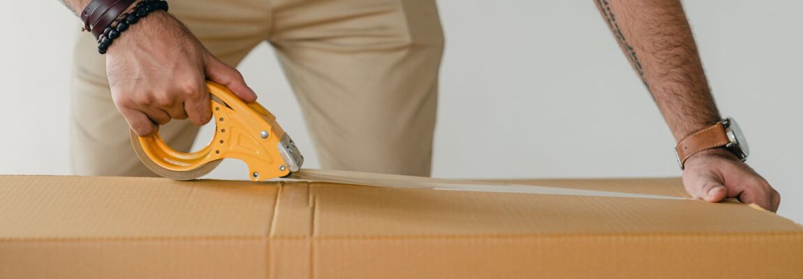 A stack of packed cardboard boxes with packing tape, ready for relocation.