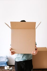Man moving a large box into a moving truck for relocation services in Kileleshwa.
