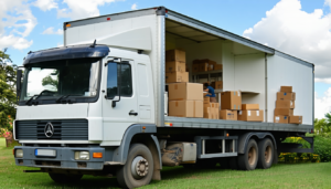 African movers carrying boxes into a truck during a home relocation in Kenya.