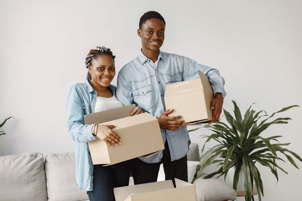 House moving experts Syokimau - Professional movers in Syokimau carrying furniture out of a house during a move.