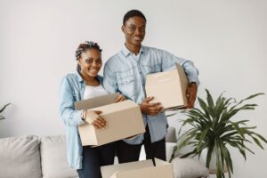 Professional movers carrying furniture out of a house in Syokimau estate.