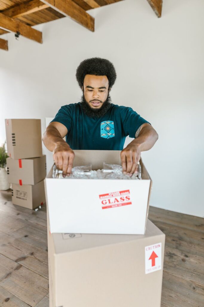 professional relocation services syokimau - Two professional house movers in Syokimau carry a large box, providing fast and r