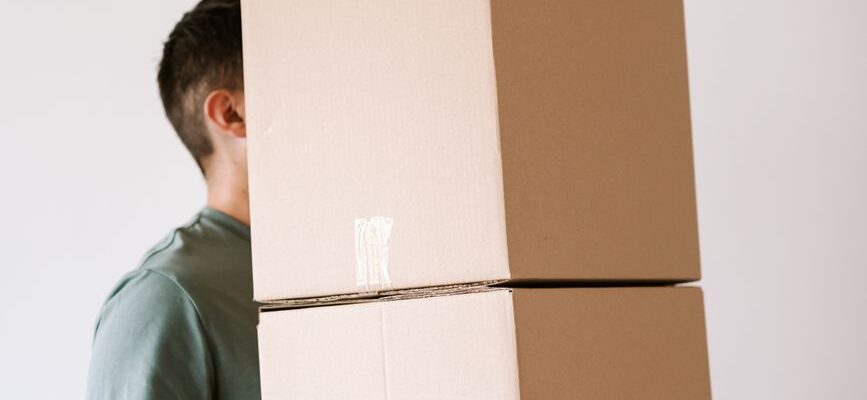 Professional movers carrying furniture into a home in Kitengela, Kenya.