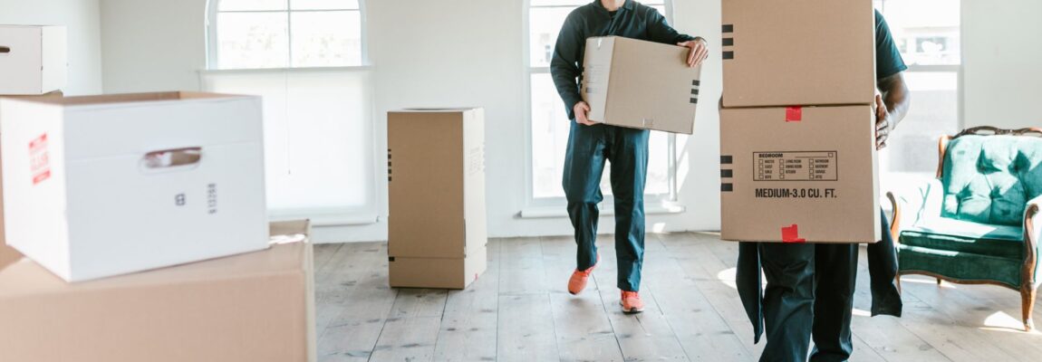 Professional moving company staff loading cardboard boxes into a moving truck in Syokimau.